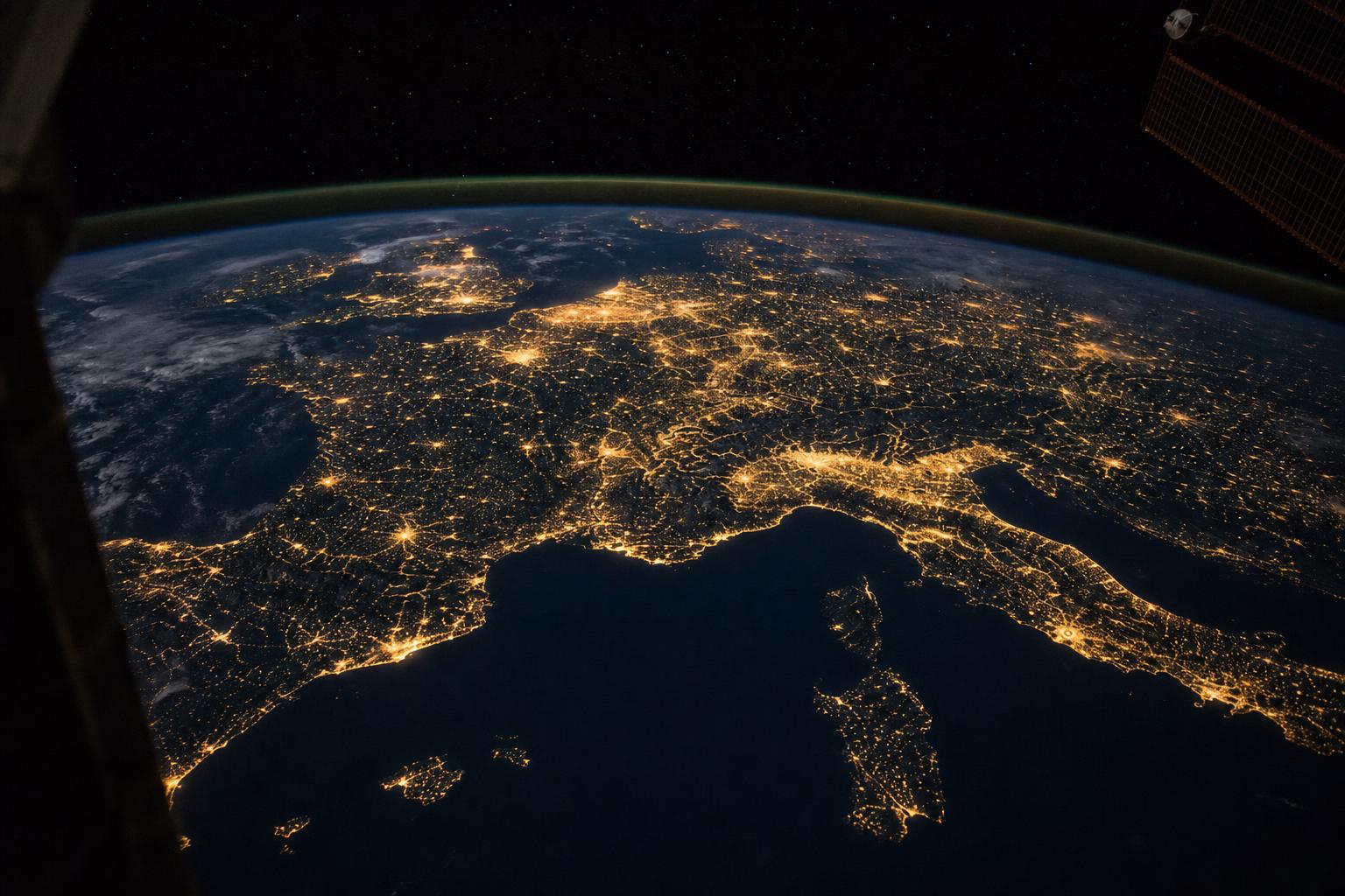 Earth from orbit, city lights across the night side